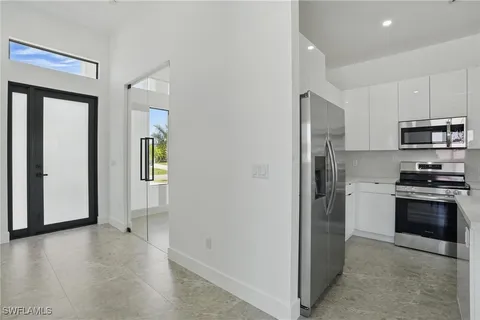 a kitchen with stainless steel appliances a refrigerator stove and microwave