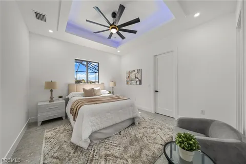 a spacious bedroom with a bed and a chandelier