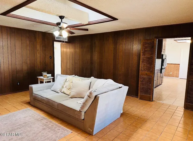 a living room with furniture and a ceiling fan