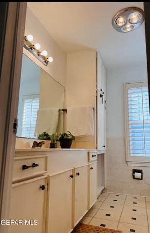 a room with a sink a stove and a window