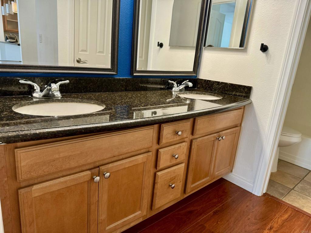 3030 Suncrest Drive, Unit 702 San Diego, CA 92108 - Photo 11 of 17 a bathroom with a sink and a mirror