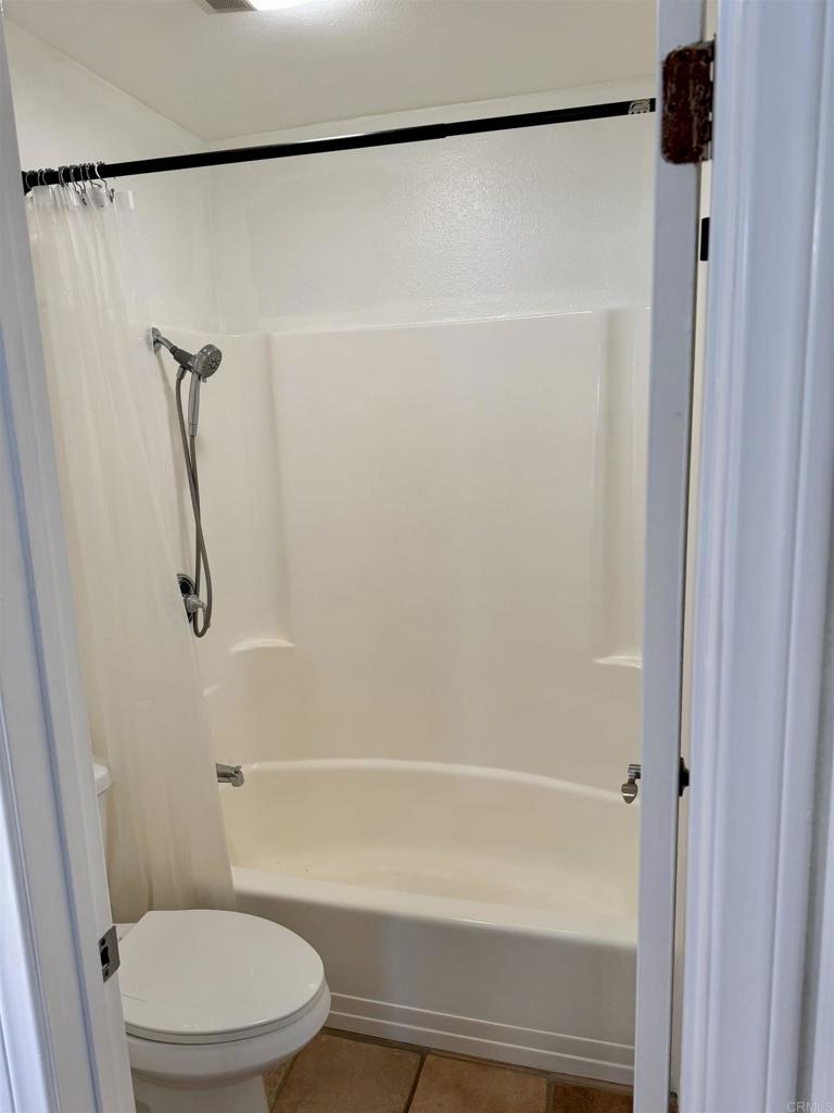 3030 Suncrest Drive, Unit 702 San Diego, CA 92108 - Photo 12 of 17 a bathroom with a shower and a toilet