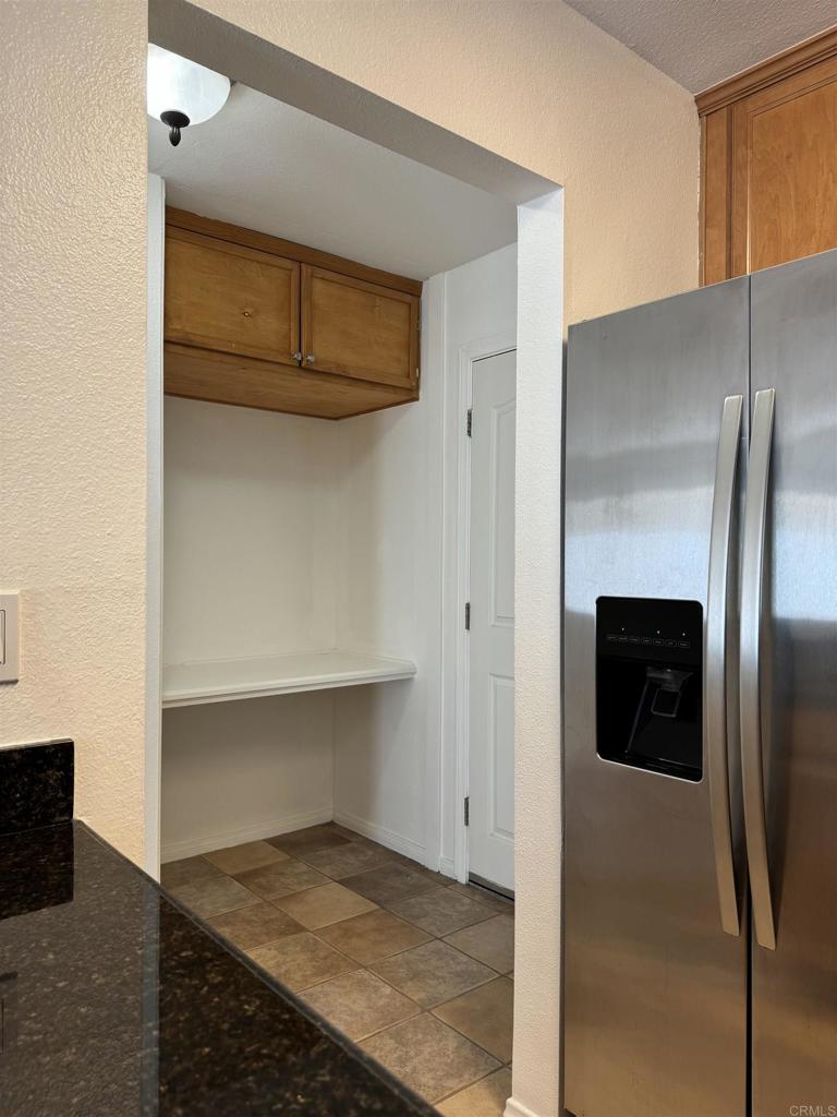 3030 Suncrest Drive, Unit 702 San Diego, CA 92108 - Photo 6 of 17 a view of a kitchen space with wooden floor and staircase