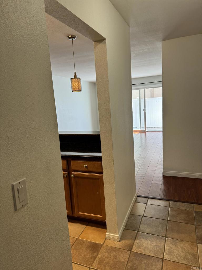 3030 Suncrest Drive, Unit 702 San Diego, CA 92108 - Photo 7 of 17 a kitchen with a refrigerator and a stove top oven