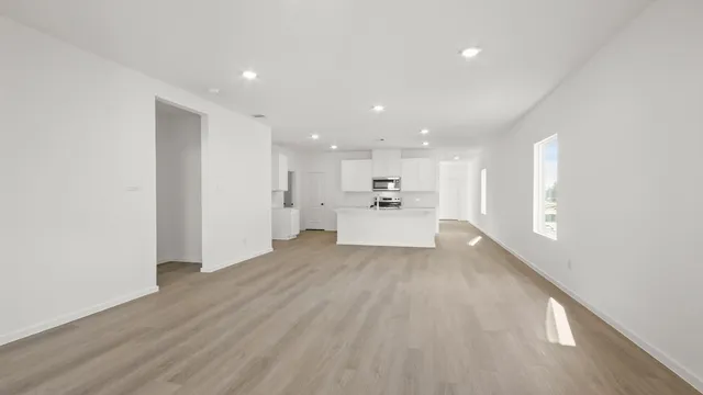 a view of a kitchen with a sink and wooden floor