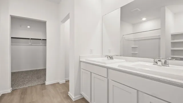 a bathroom with a double vanity sink and mirror