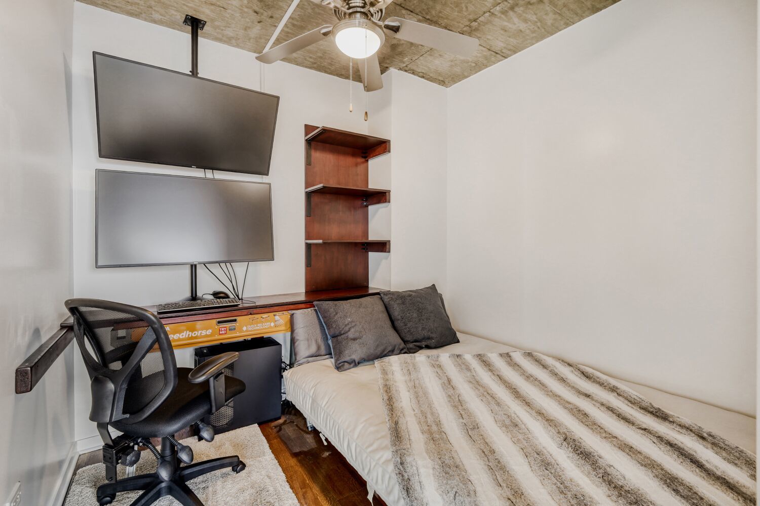 611 South Wells Street, Unit 2304 Chicago, IL 60607 - Photo 12 of 20 a bedroom with a bed and a flat tv screen on the dresser