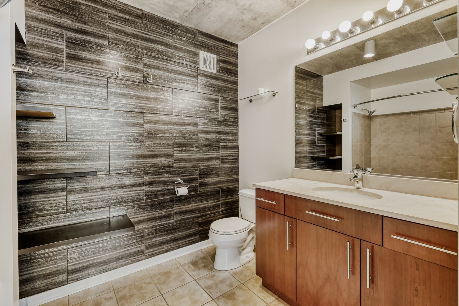 611 South Wells Street, Unit 2304 Chicago, IL 60607 - Photo 9 of 20 a bathroom with a sink a toilet a mirror and shower