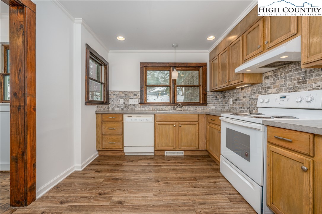 217 Highland Avenue Boone, NC 28607 - Photo 12 of 33 a kitchen with stainless steel appliances granite countertop a stove and a sink