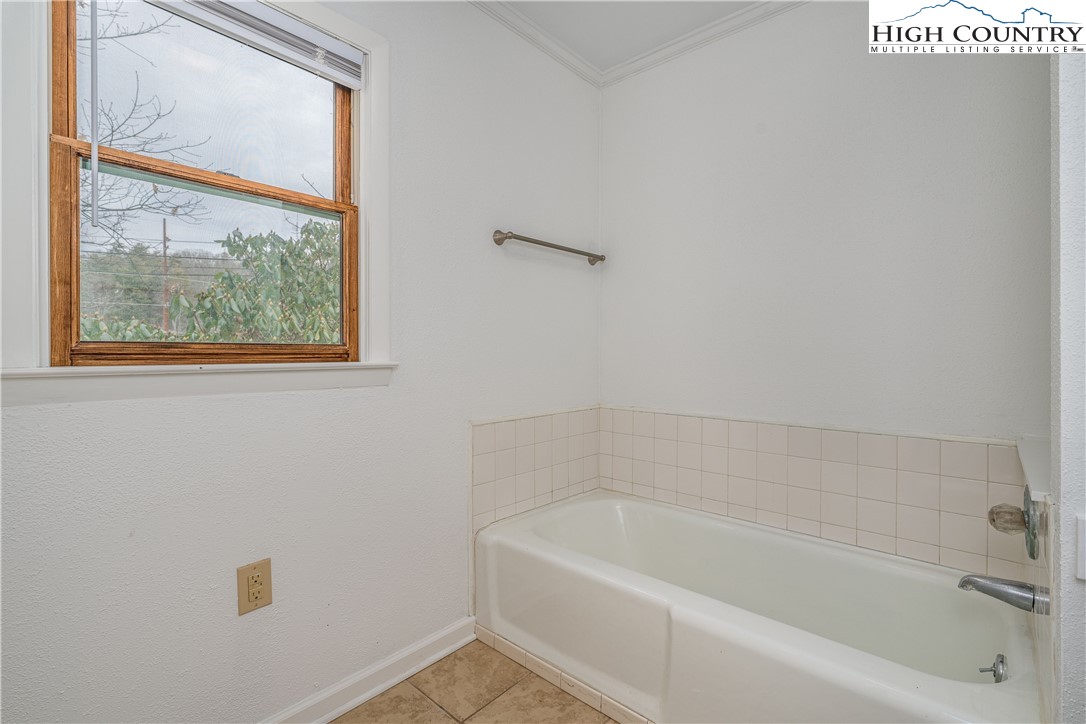 217 Highland Avenue Boone, NC 28607 - Photo 20 of 33 a white bath tub sitting next to a white window