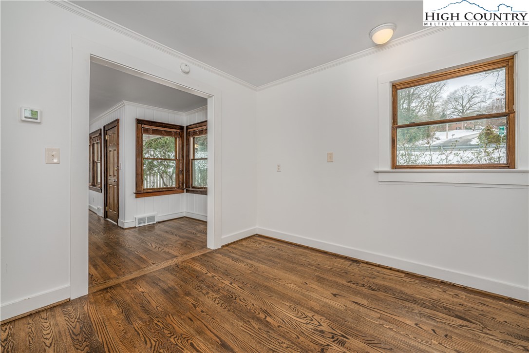 217 Highland Avenue Boone, NC 28607 - Photo 9 of 33 an empty room with wooden floor and windows