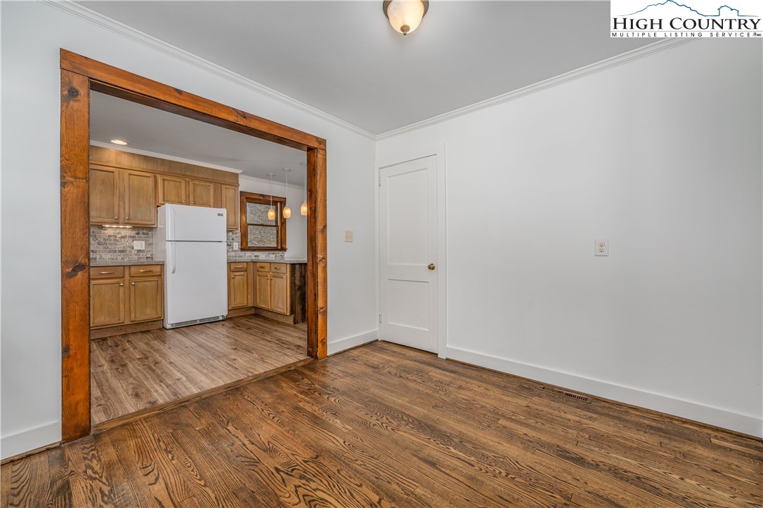 217 Highland Avenue Boone, NC 28607 - Photo 10 of 33 a view of a room with wooden floor and a kitchen