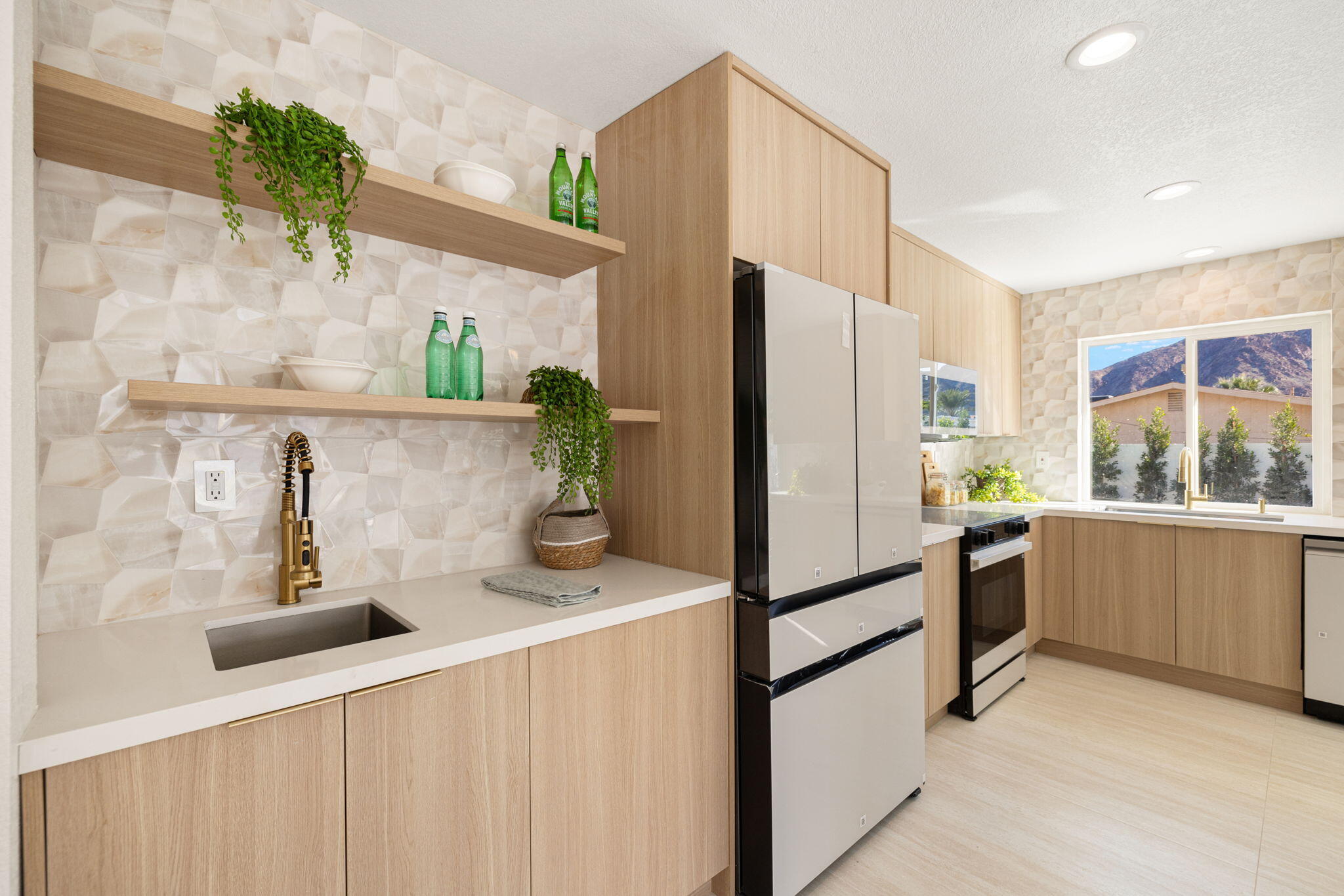 53770 Avenida Obregon La Quinta, CA 92253 - Photo 11 of 36 a kitchen with stainless steel appliances a refrigerator and a sink