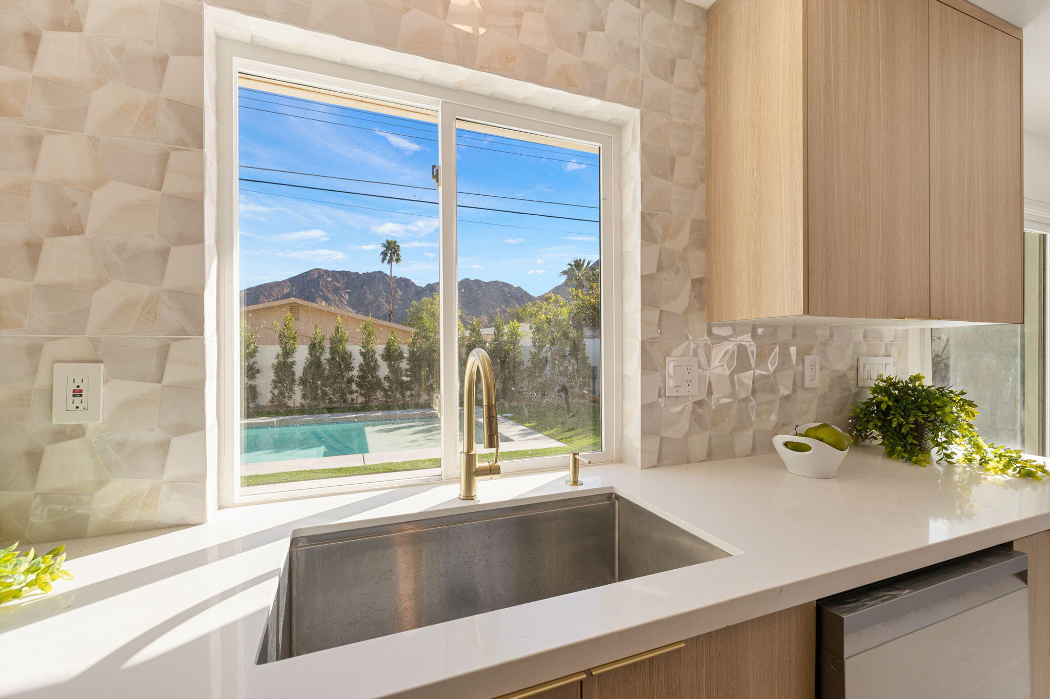 53770 Avenida Obregon La Quinta, CA 92253 - Photo 13 of 36 a view of a sink and a large window with garden view