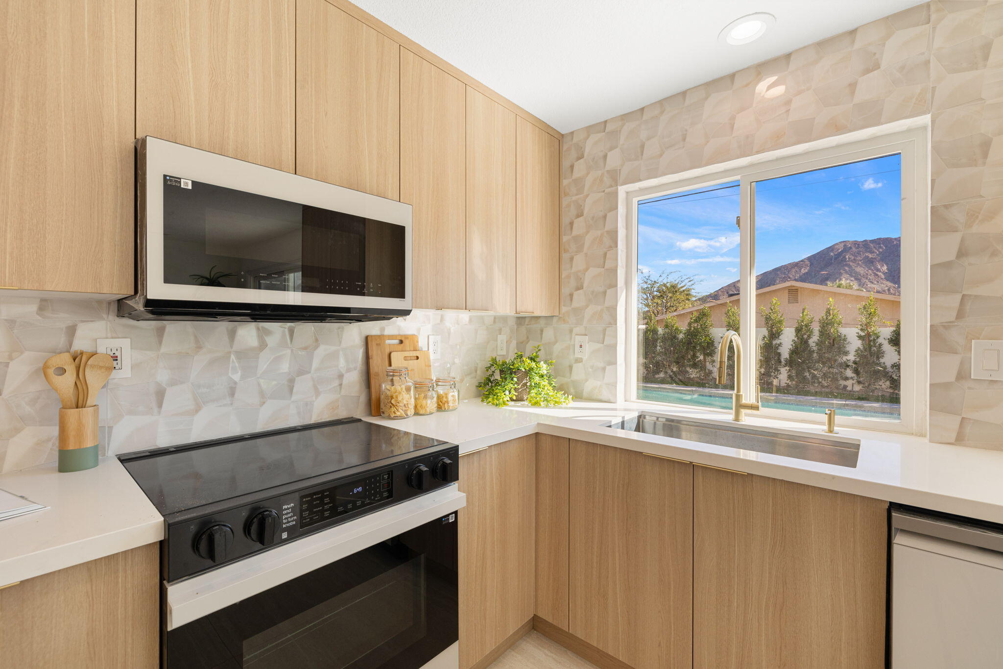 53770 Avenida Obregon La Quinta, CA 92253 - Photo 14 of 36 a kitchen with a stove and a microwave