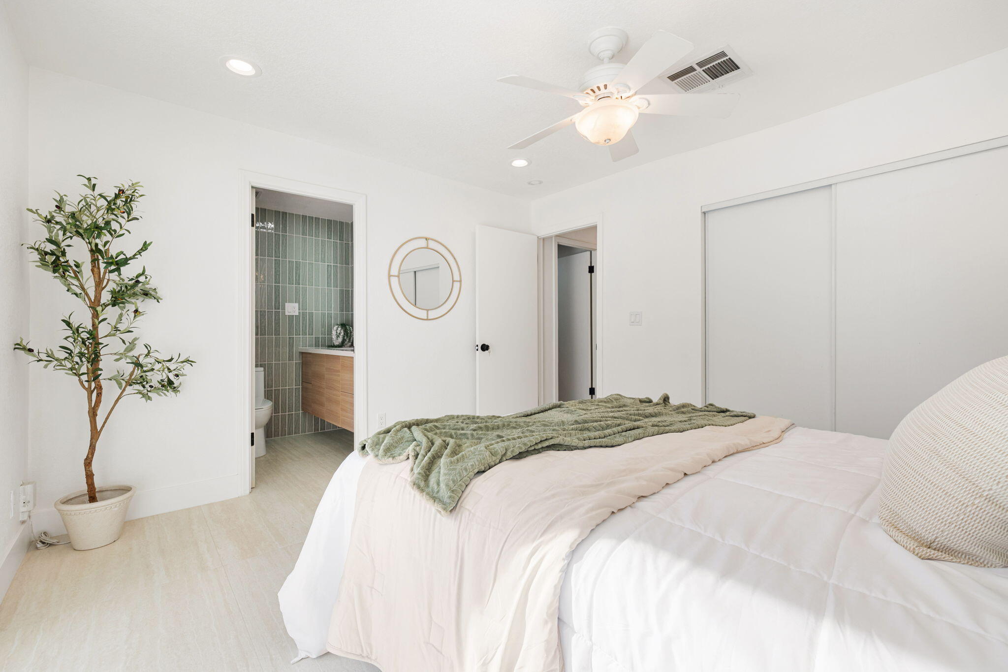 53770 Avenida Obregon La Quinta, CA 92253 - Photo 19 of 36 a spacious bedroom with a bed and a potted plant