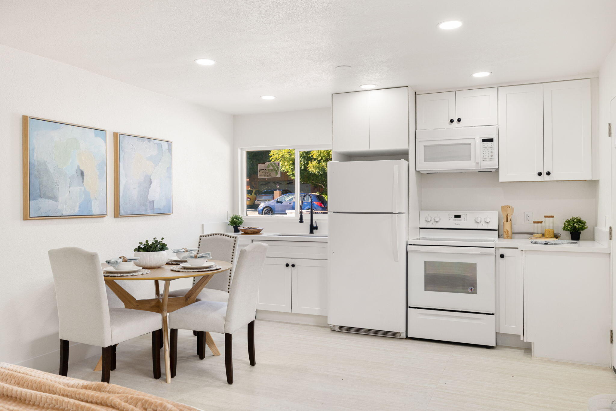 53770 Avenida Obregon La Quinta, CA 92253 - Photo 24 of 36 a kitchen with a white cabinets and chairs
