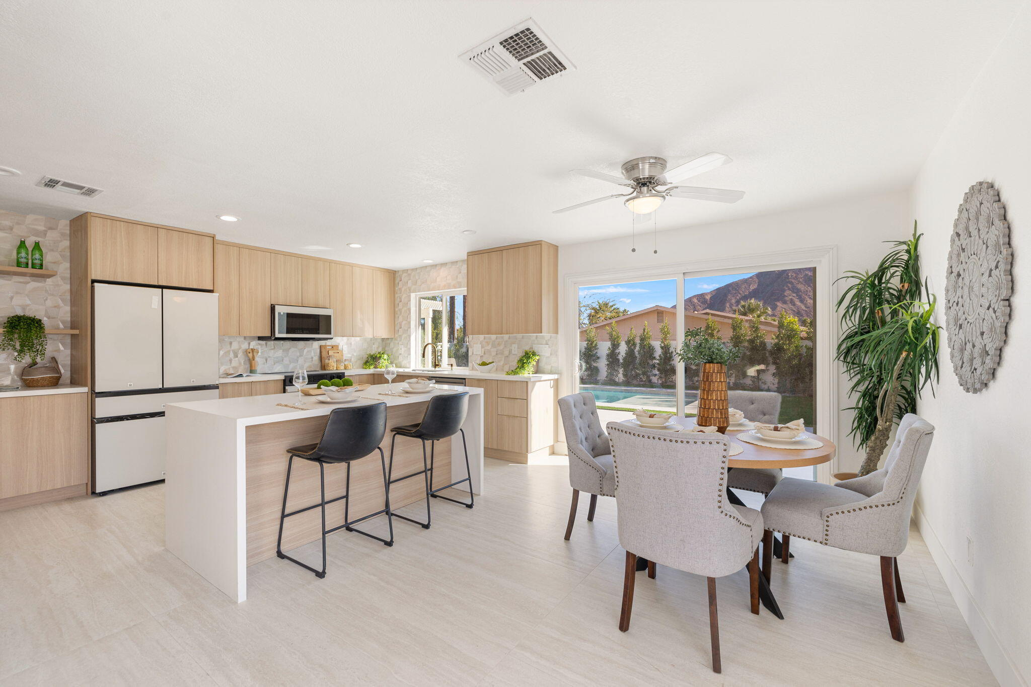 53770 Avenida Obregon La Quinta, CA 92253 - Photo 9 of 36 a kitchen with a table chairs refrigerator and cabinets