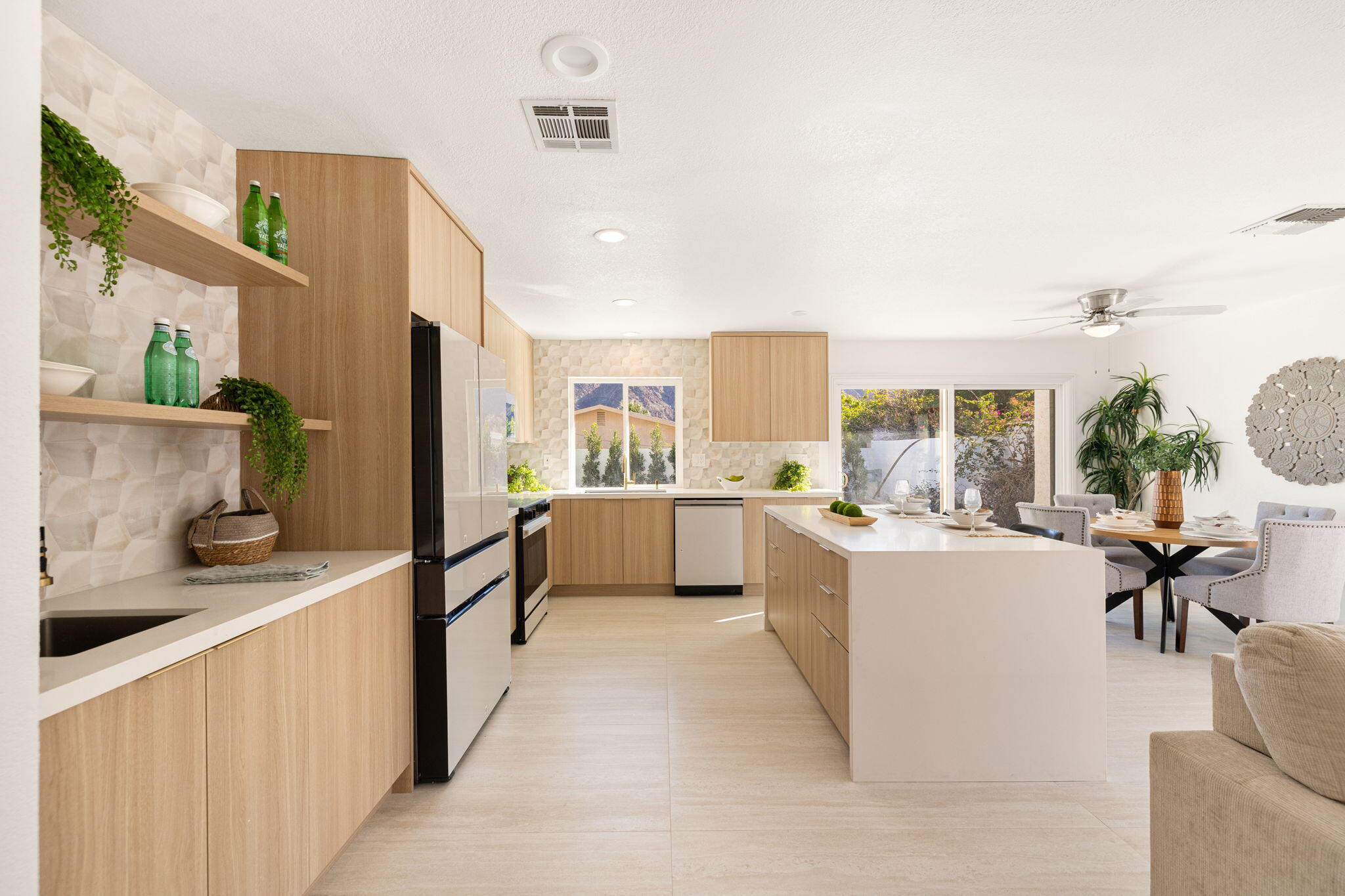 53770 Avenida Obregon La Quinta, CA 92253 - Photo 10 of 36 a large white kitchen with cabinets a sink and a stove top oven