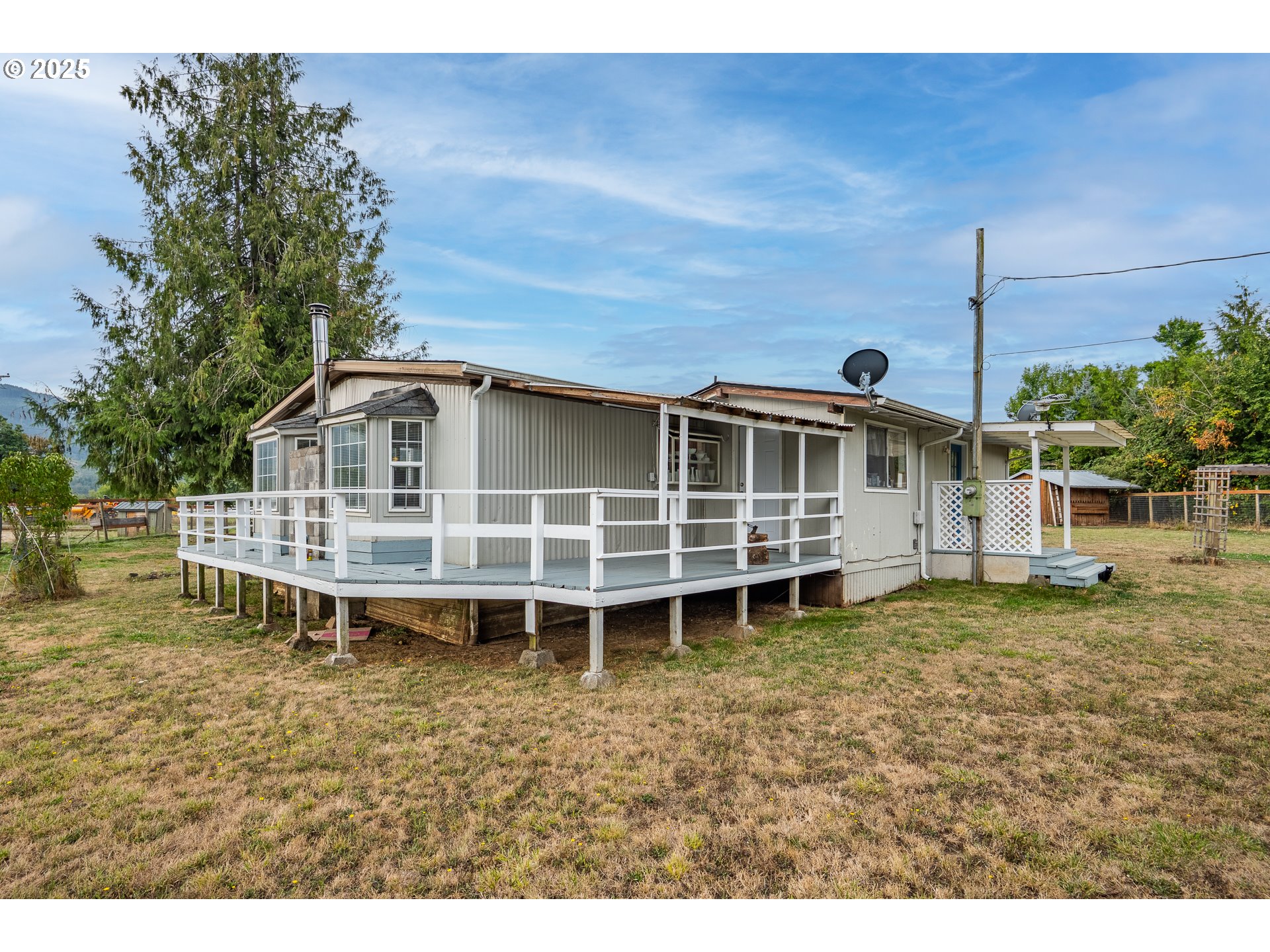 a view of a house with a backyard and deck