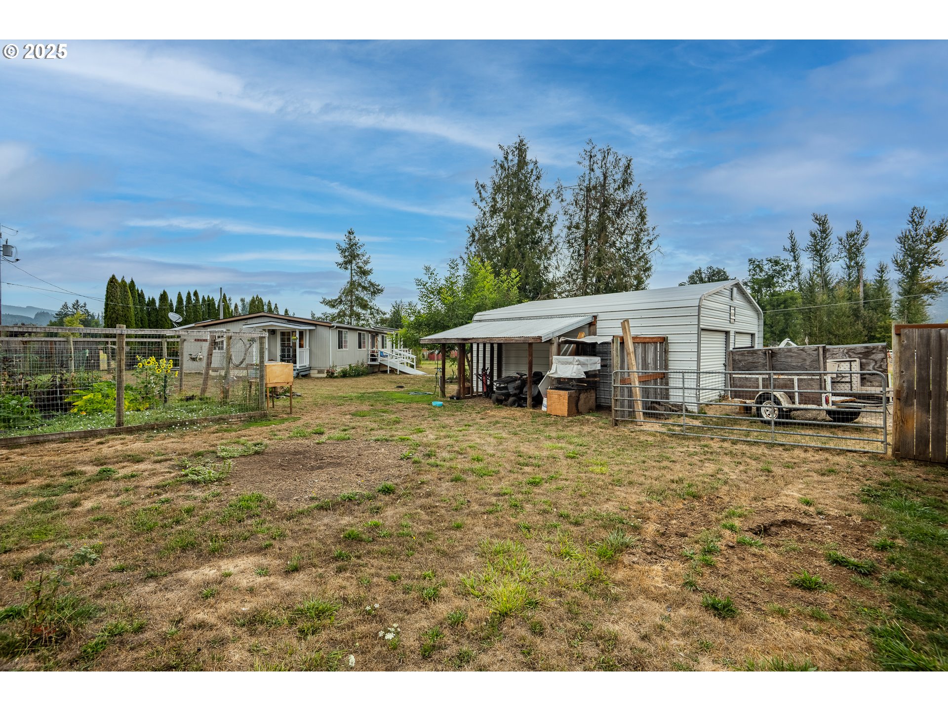 90948 Sunderman Road Springfield, OR 97478 - Photo 30 of 44 a view of a big house with wooden fence