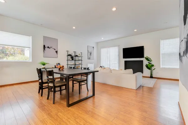 a kitchen with kitchen island white cabinets and stainless steel appliances