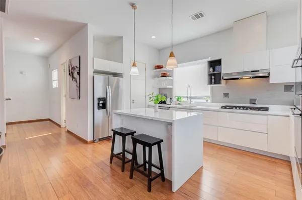 a kitchen with a stove and a refrigerator