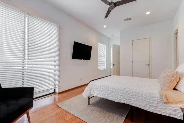 a bedroom with a bed table and a window