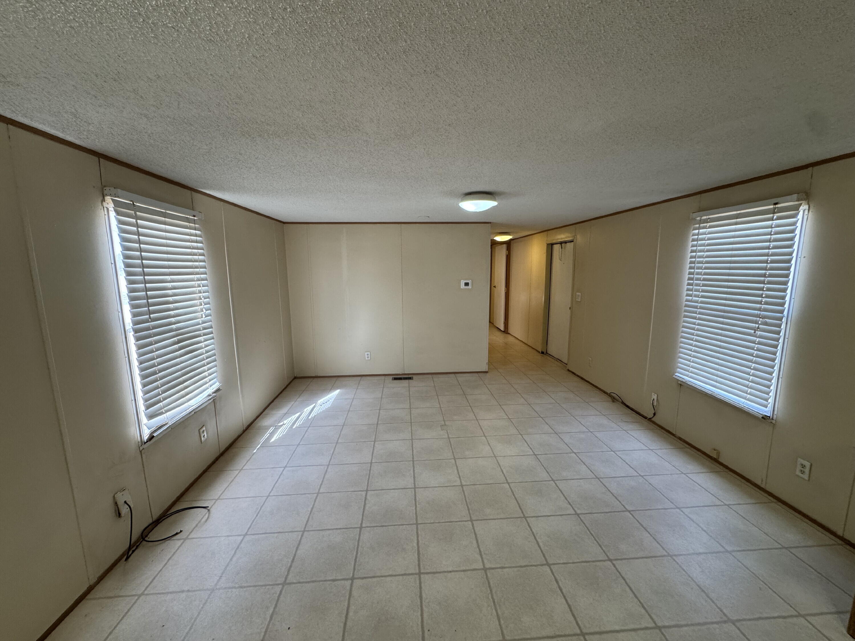 7008 North C R 1500, Unit 20 Shallowater, TX 79363 - Photo 2 of 8 a view of an empty room with a window