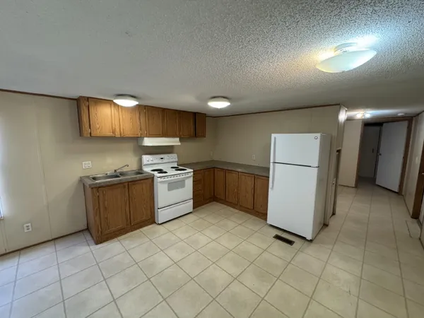 a kitchen with a cabinets and a refrigerator