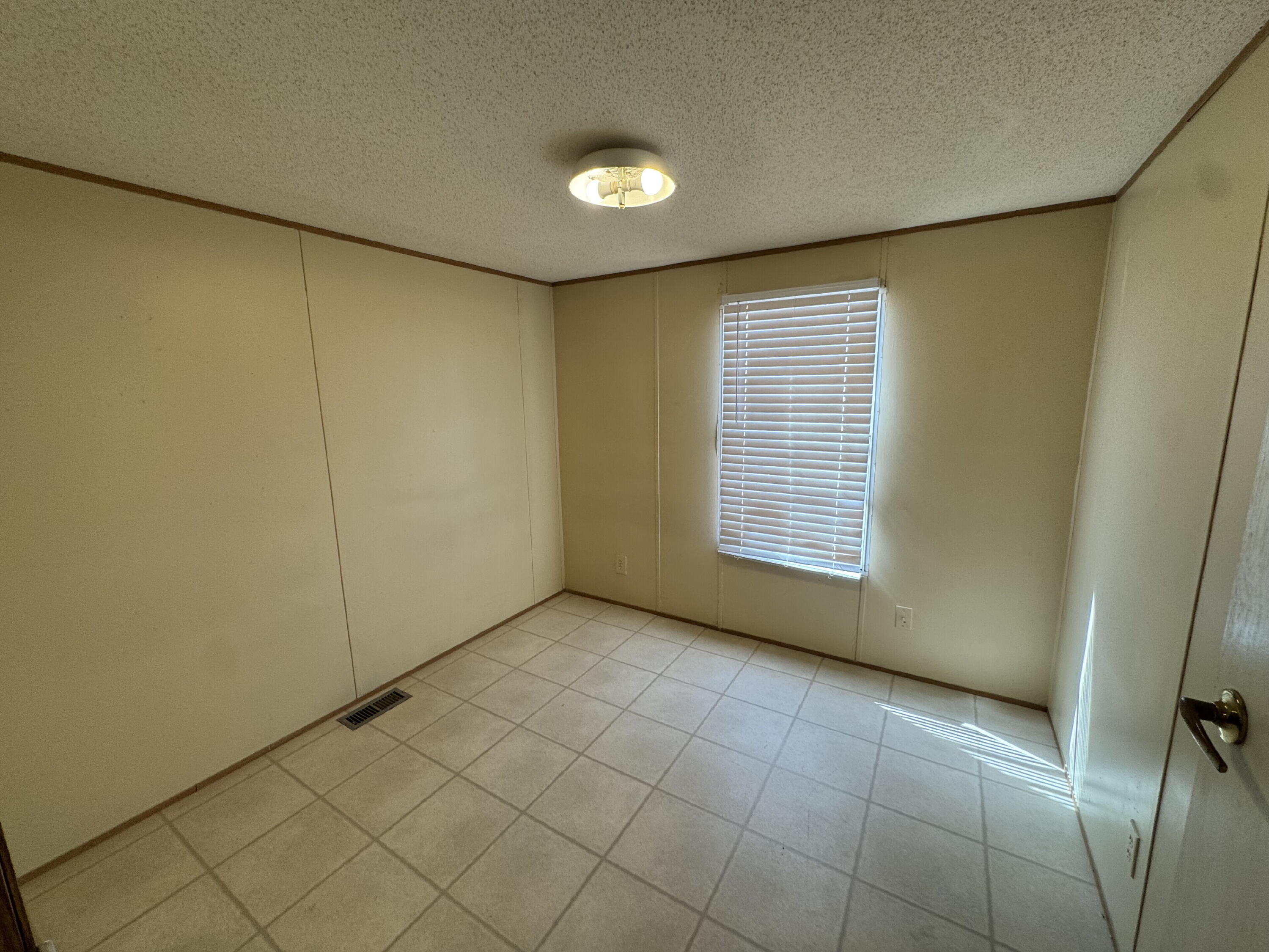 7008 North C R 1500, Unit 20 Shallowater, TX 79363 - Photo 4 of 8 a view of an empty room with a window