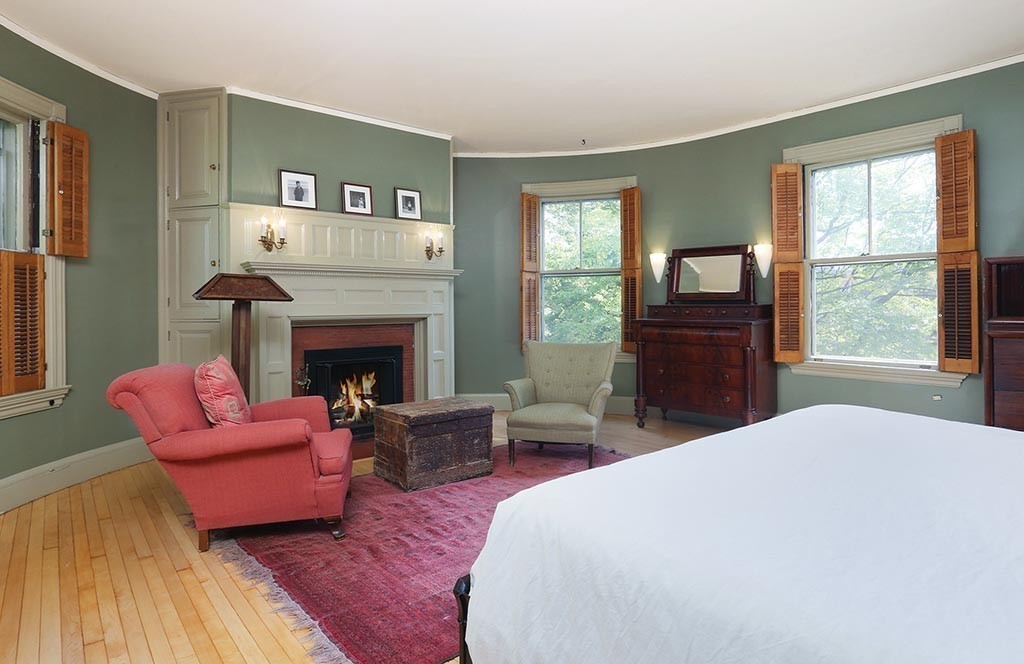 23 Philbrick Road Brookline, MA 02445 - Photo 8 of 10 a bedroom with a bed and a fireplace