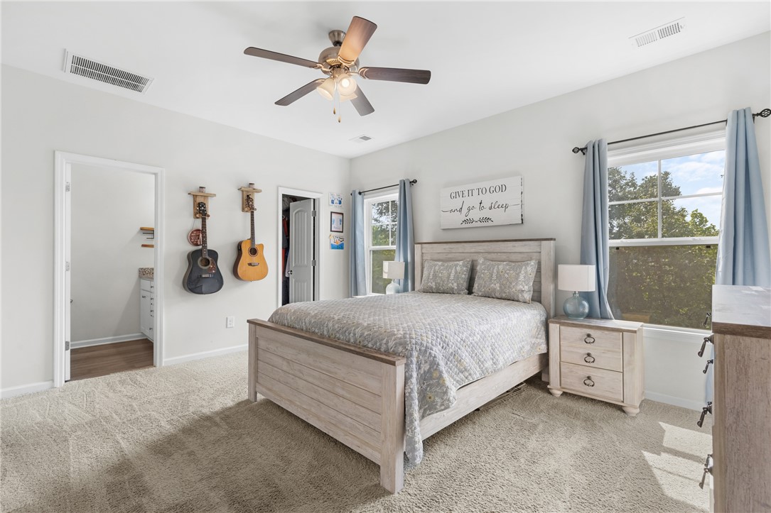 768 Rocky Ridge Circle Seneca, SC 29678 - Photo 16 of 30 A naturally illuminated bedroom offers comfort and ample space with soft carpeting and ceiling fan.