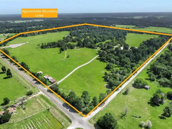 a view of a pathway with a wrought fence