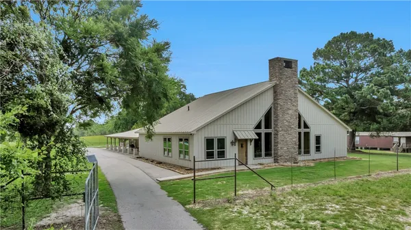 a aerial view of a house with swimming pool and yard