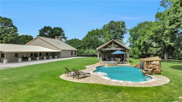 a swimming pool with barbeque oven in front of it
