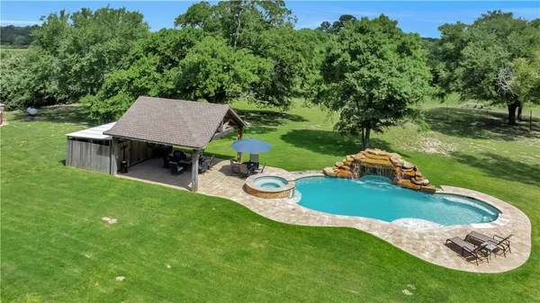 an aerial view of a house with a garden and trees