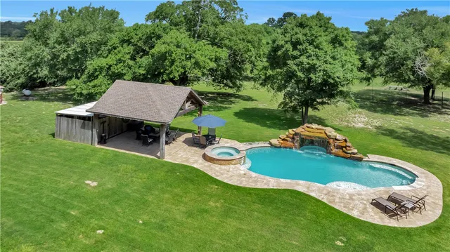an aerial view of a house with a garden and trees