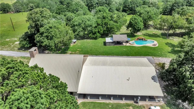 an aerial view of a house with yard and outdoor seating