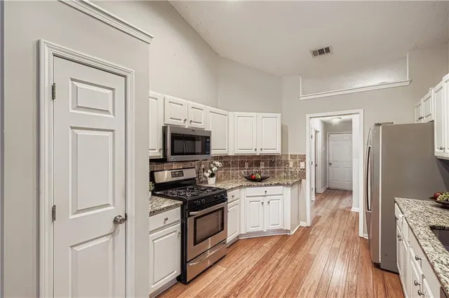 a kitchen with a refrigerator stove and sink