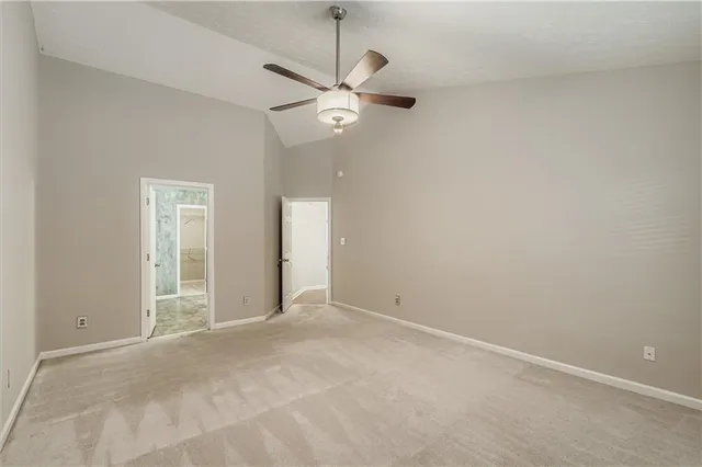 a view of an empty room with a ceiling fan
