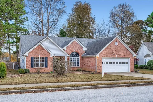 a view of a house next to a road and yard
