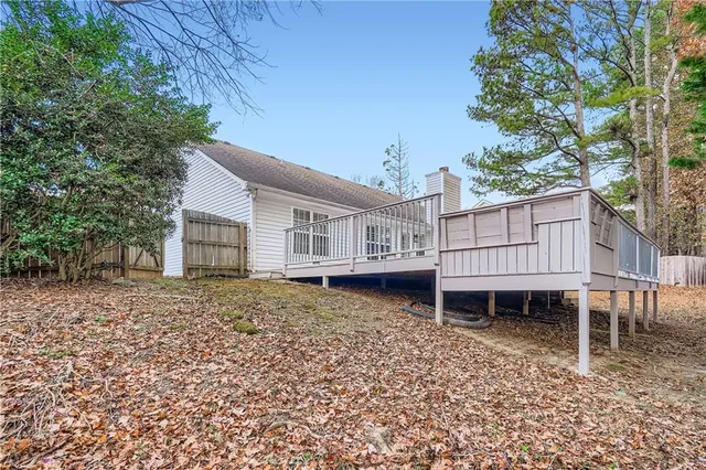 a view of balcony with wooden floor and fence