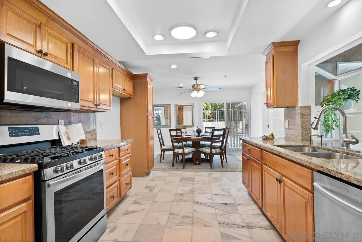 719 Mahogany Drive El Cajon, CA 92019 - Photo 14 of 30 a kitchen with stainless steel appliances granite countertop a stove a sink and a microwave
