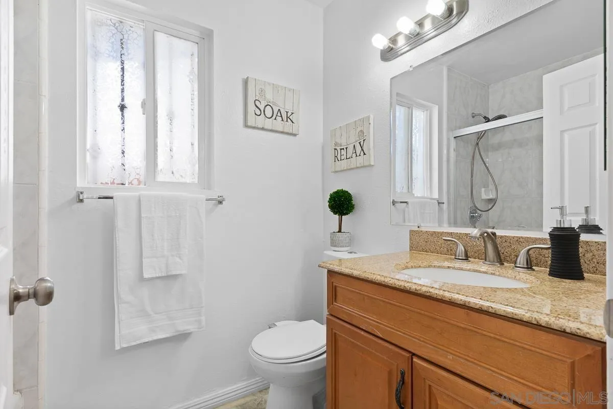 719 Mahogany Drive El Cajon, CA 92019 - Photo 22 of 30 a bathroom with a granite countertop sink toilet and shower
