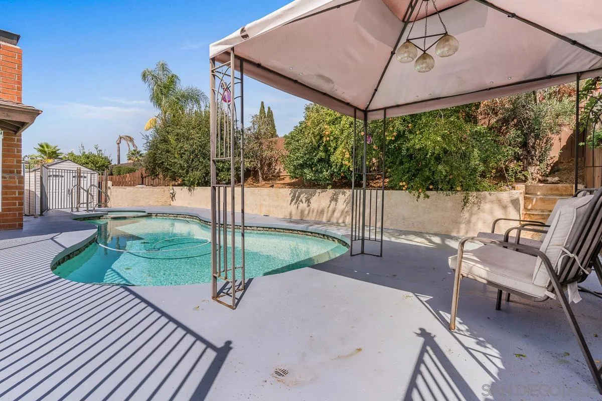 719 Mahogany Drive El Cajon, CA 92019 - Photo 29 of 30 a view of a patio with table and chairs under an umbrella