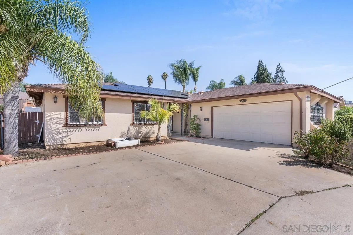 719 Mahogany Drive El Cajon, CA 92019 - Photo 4 of 30 a very nice looking house with a large window and potted plants