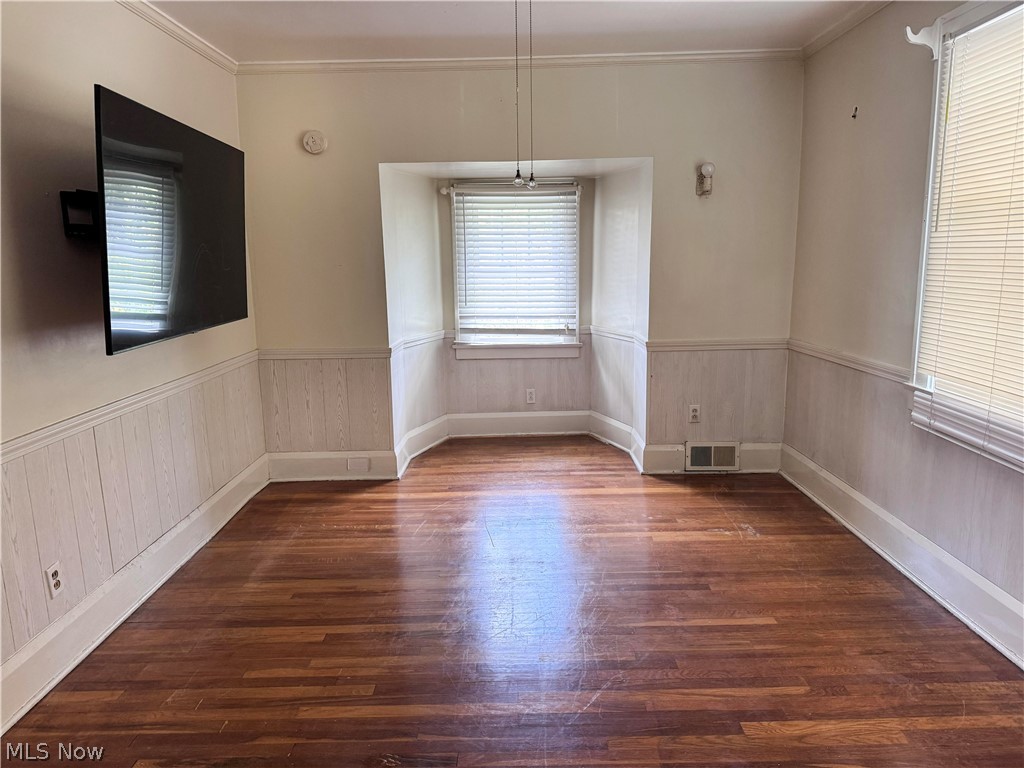 7121 North Lima Road Youngstown, OH 44514 - Photo 25 of 37 Spacious room featuring wood-finish flooring, wainscoting, and crown molding