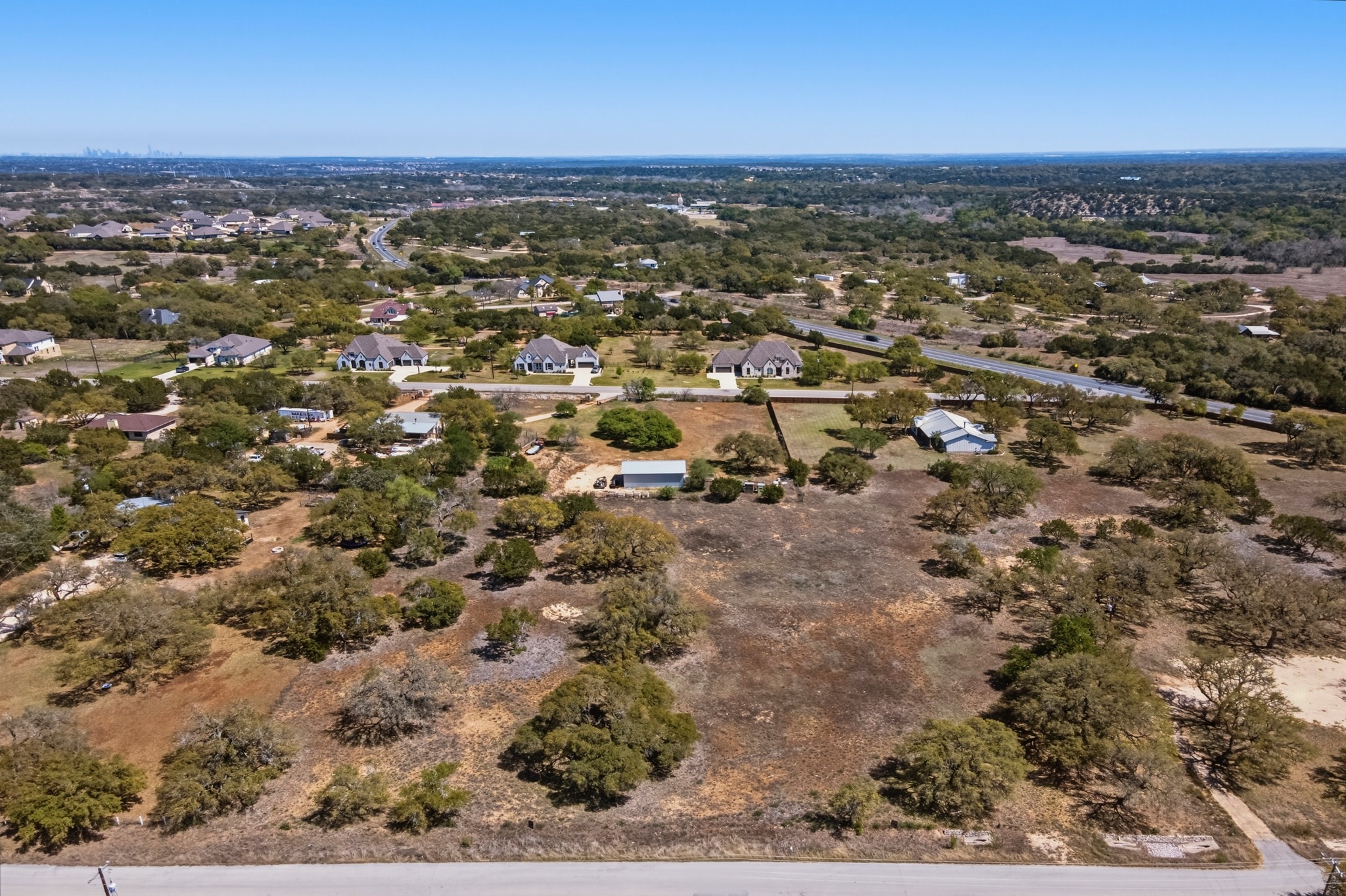 268 Kinnikinik Loop Austin, TX 78737 - Photo 6 of 32 an aerial view of residential building with trees
