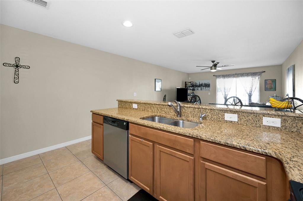 9736 Trumpet Vine Loop Trinity, FL 34655 - Photo 19 of 35 a kitchen with a sink and cabinets